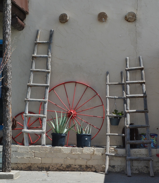 adobe bldg with ladders and wheel
